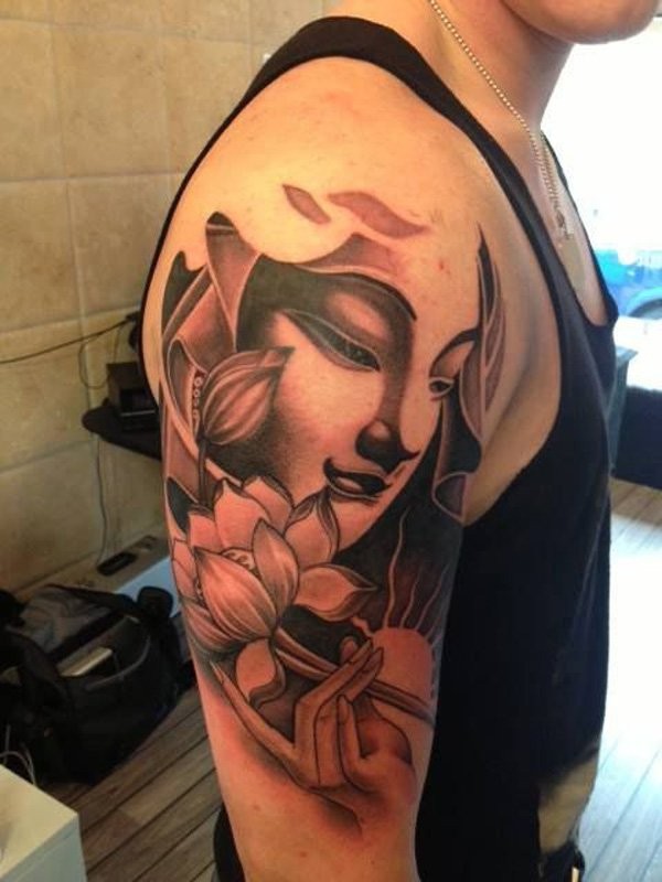 Black and gray style shoulder tattoo of Buddha with lotus flower