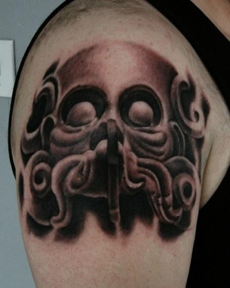 Black and gray style shoulder tattoo of demonic face with fog