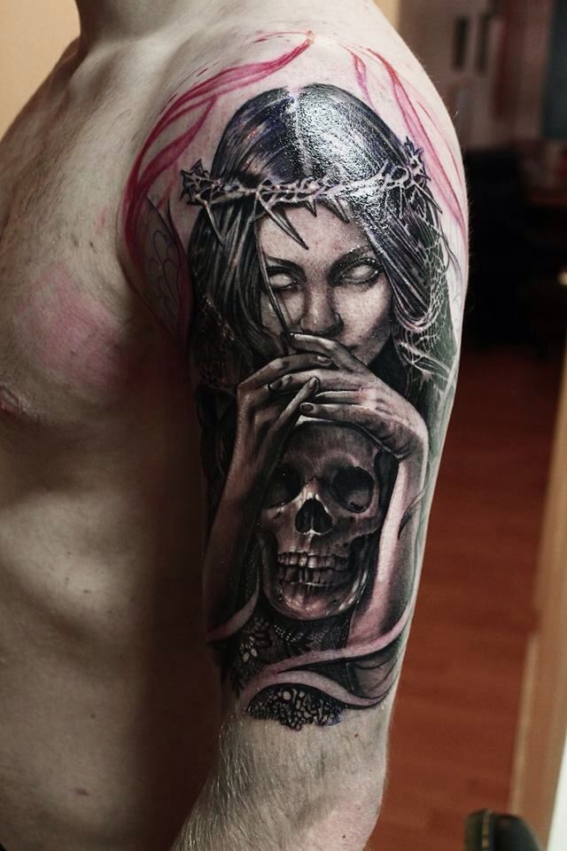Black and gray style shoulder tattoo of demonic woman with human skull