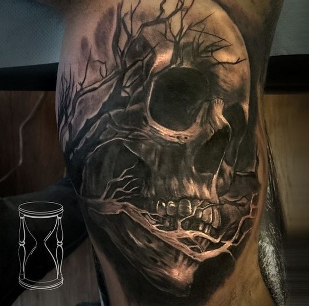 Black and gray style very detailed biceps tattoo of human skull with tree