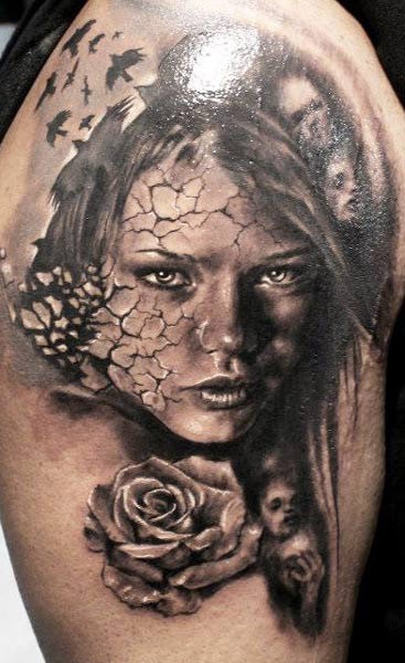 Black and gray style very detailed shoulder tattoo of woman with corrupted face and rose