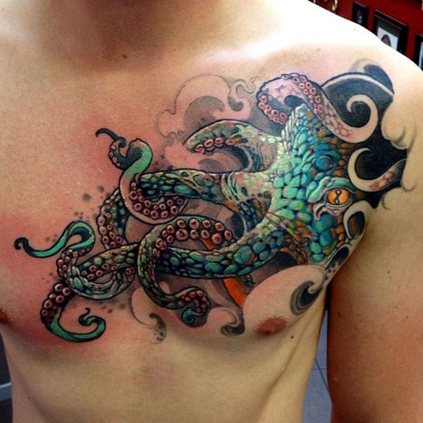 Black and green octopus with orange eye tattoo on chest