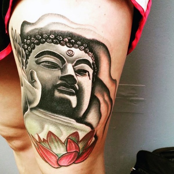 Black and white colored thigh tattoo of Buddha statue with lotus flower