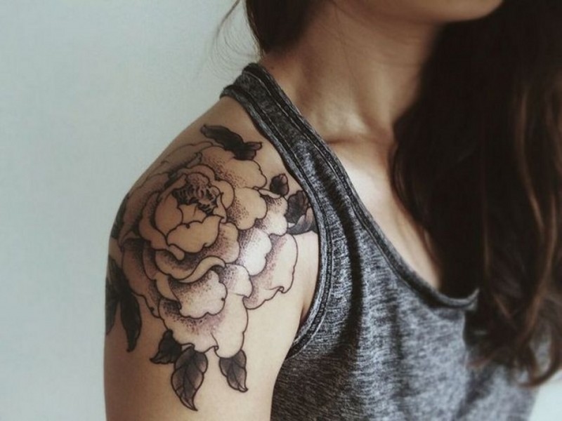 Black and white detailed massive peony flower tattoo on arm top