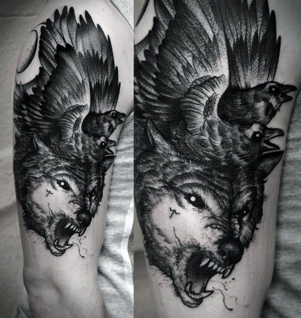 Black and white engraving style shoulder tattoo fo roaring wolf with crows