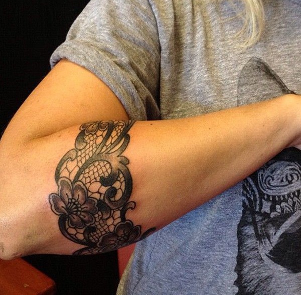 Black and white floral style armband tattoo on arm