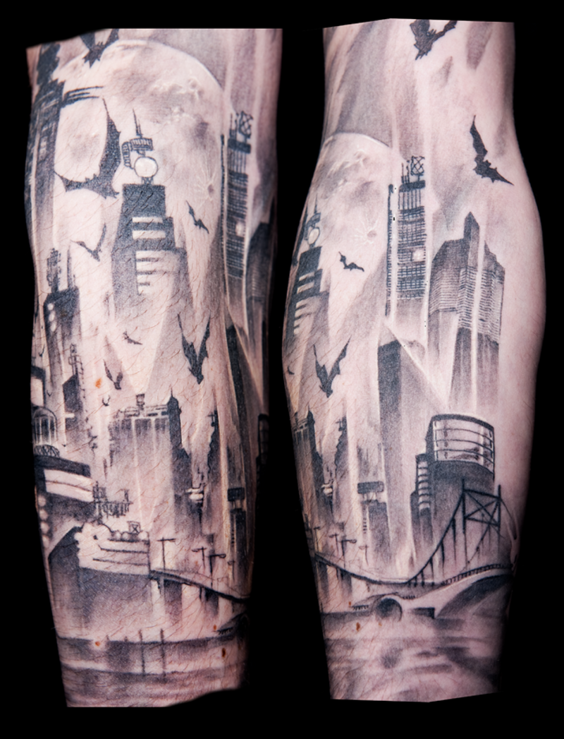 Black and white forearm tattoo of abandoned city with bats