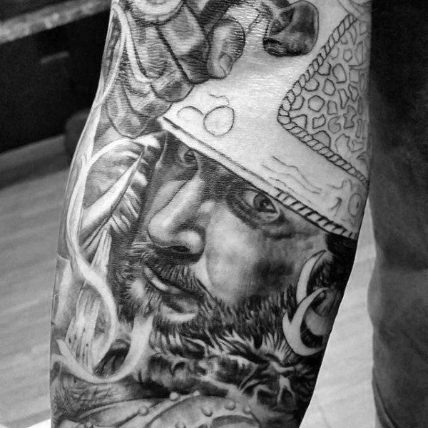 Black and white interesting looking warrior tattoo on sleeve