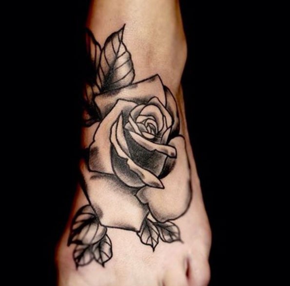 Black and white massive rose flower tattoo on foot