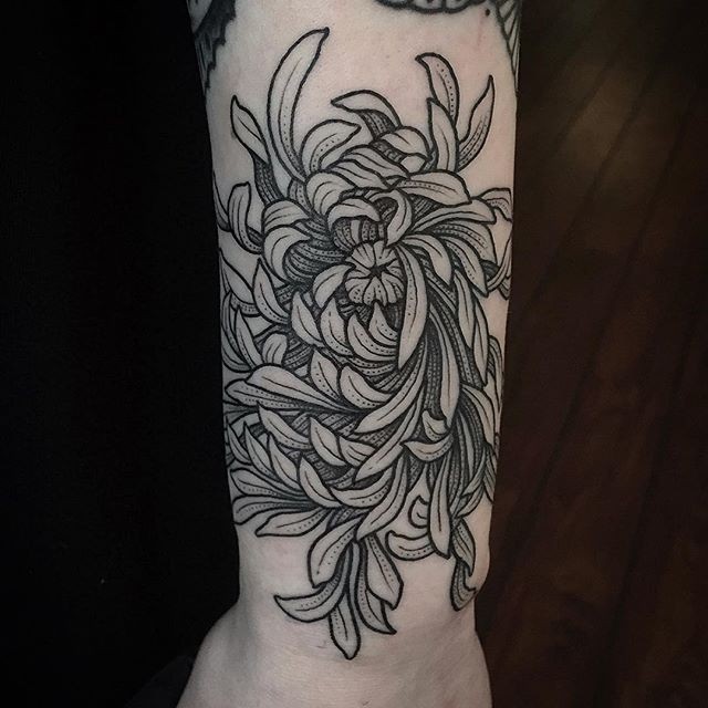 Black and white naturally looking detailed chrysanthemum flower arm tattoo