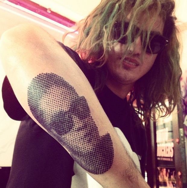 Black and white portrait in sunglasses forearm tattoo in dotted work technique