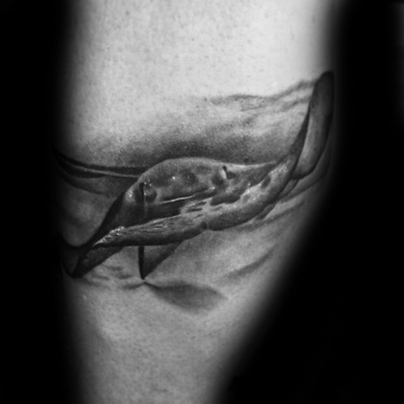 Black and white real underwater photo like leg tattoo of ray