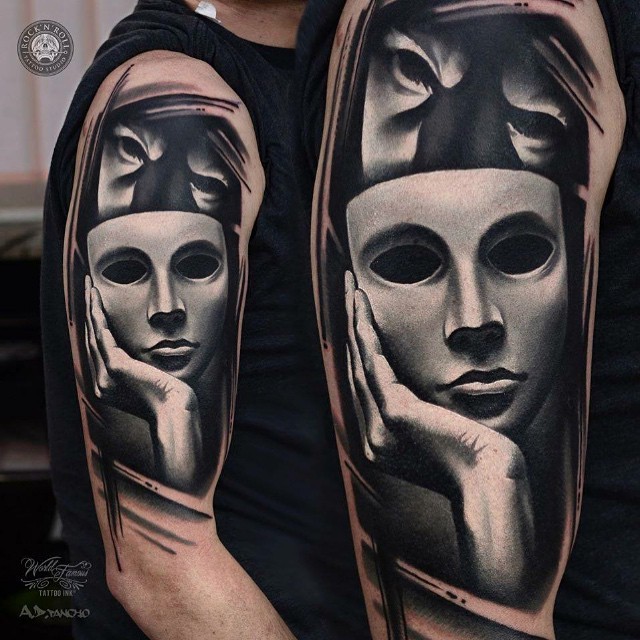Black and white realistic looking shoulder tattoo of terrifying face with mask