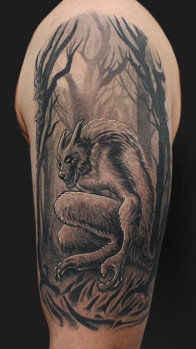 Black and white shoulder tattoo of demonic werewolf with dark forest