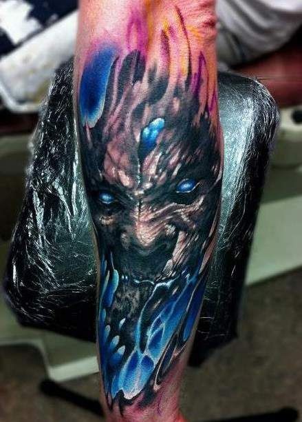 Black blue demon tattoo on forearm
