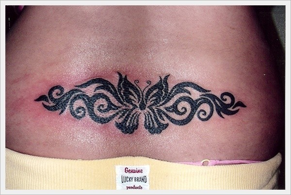 Black butterfly with patterns tattoo on lower back