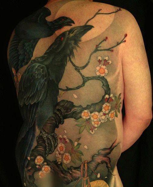 Black crows on a flowering tree tattoo