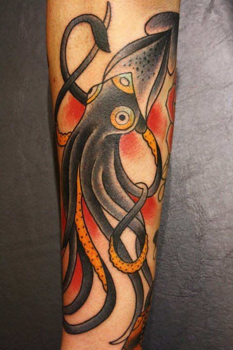Black cuttlefish tattoo on arm