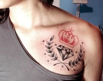 Tatuaje en el hombro,
corona roja con diamante y hojas de laurel