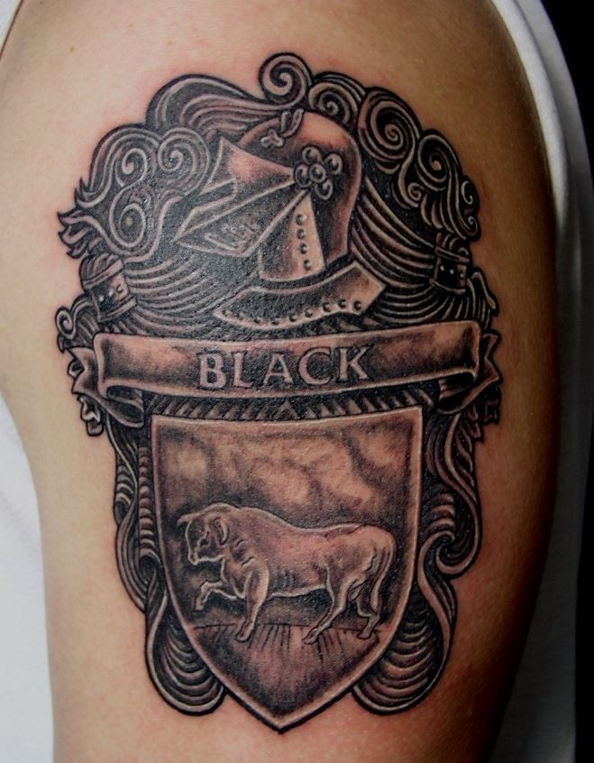 Black family crest with bull tattoo on half sleeve
