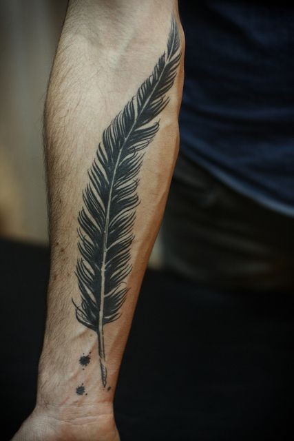 Black feather forearm tattoo