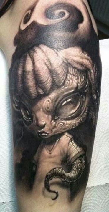 Tatuaje  de criatura pequeña extraterrestre en el brazo