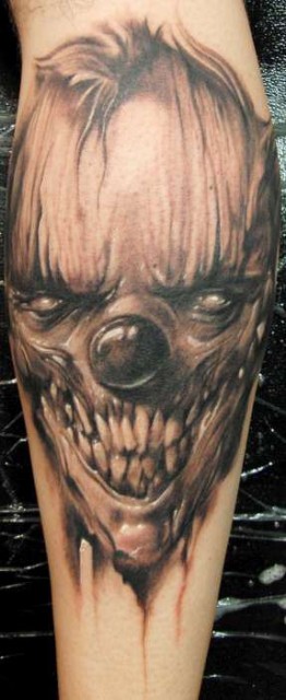 Black gray spooky clown tattoo