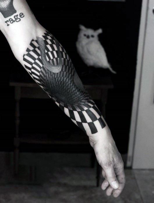 Black ink 3D style hypnotic ornament tattoo on forearm