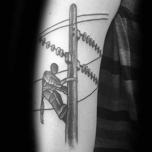 Black ink amazing arm tattoo of lineman