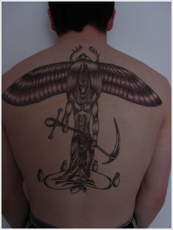 Black ink anubis and scarab tattoo on back