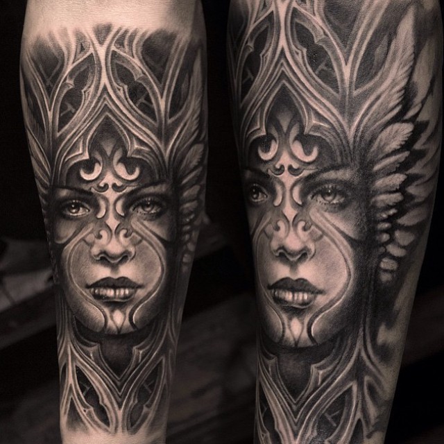 Black ink arm tattoo of tribal woman with ornaments