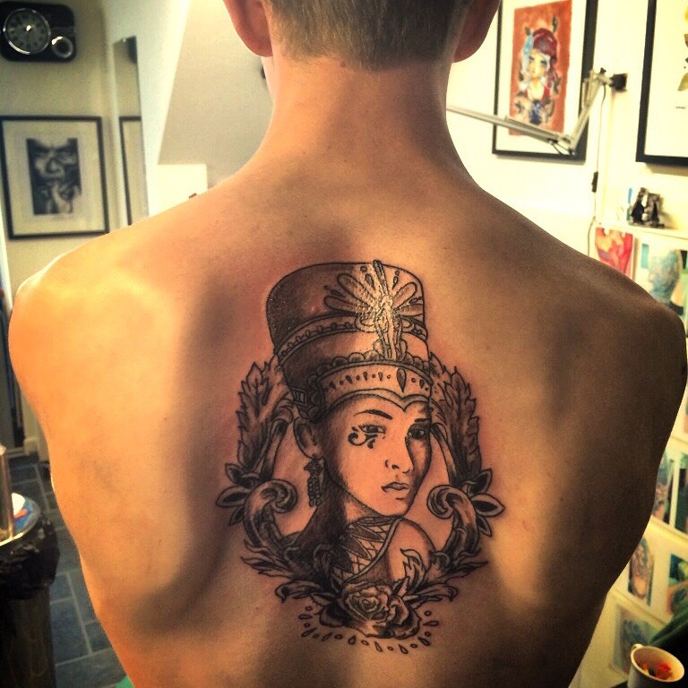 Black ink back tattoo of Egypt woman with crown