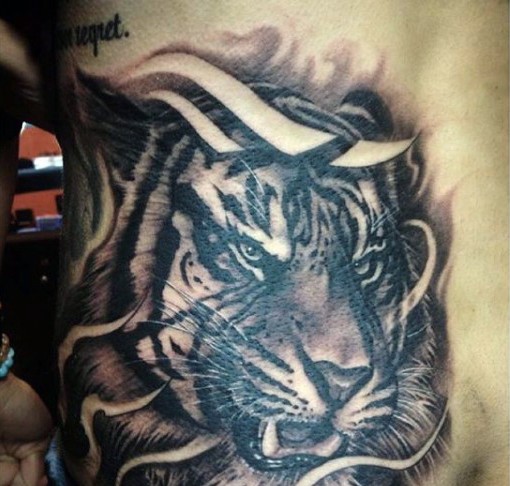 Black ink back tattoo of tiger head
