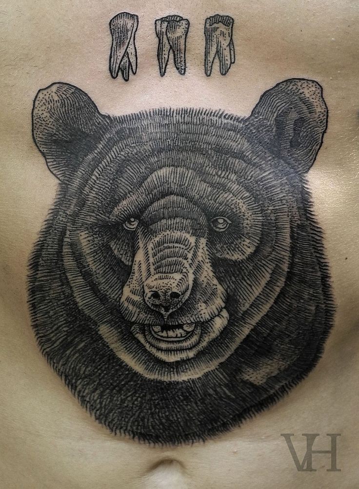 Black ink bear and bear teeth tattoo on stomach