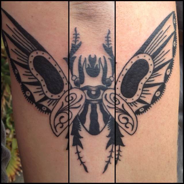 Black ink beautiful looking forearm tattoo of big bug