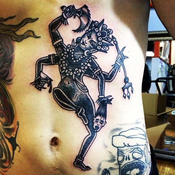 Black ink belly tattoo of creepy Hinduism God