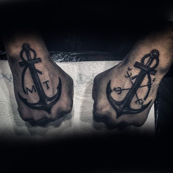 Black ink big engraving style anchors tattoo on hands