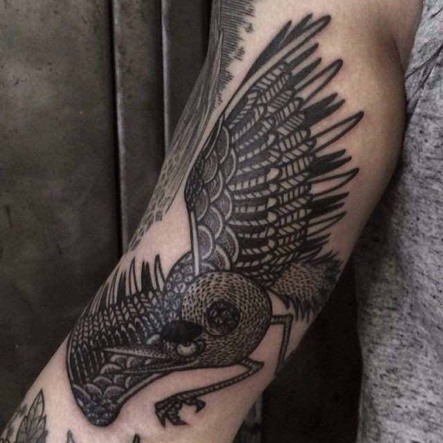 Black ink bird arm detailed tattoo