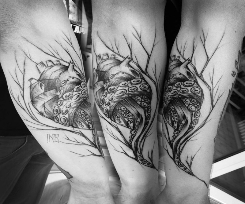 Black ink cool sketch style forearm tattoo of human heart with tree