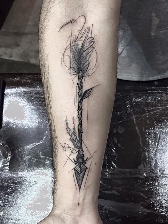 Black ink creative looking forearm tattoo of ancient arrow