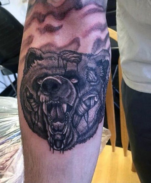 Black ink creepy looking forearm tattoo of zombie bear head