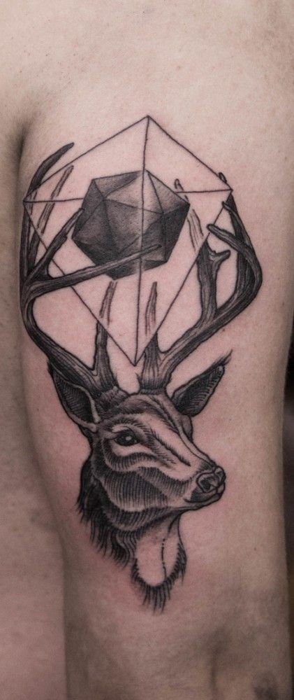 Tatuaje en el brazo, ciervo y figura geométrica sobre cuernos
