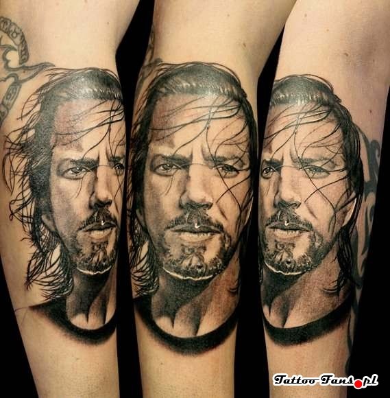 Black ink detailed arm tattoo of man face with beard