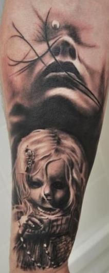Black ink detailed black ink mystical woman face tattoo on forearm with creepy doll