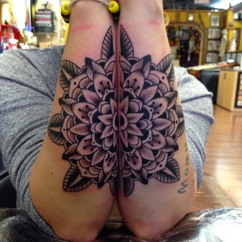Black ink detailed forearm tattoo of Hinduism flowers