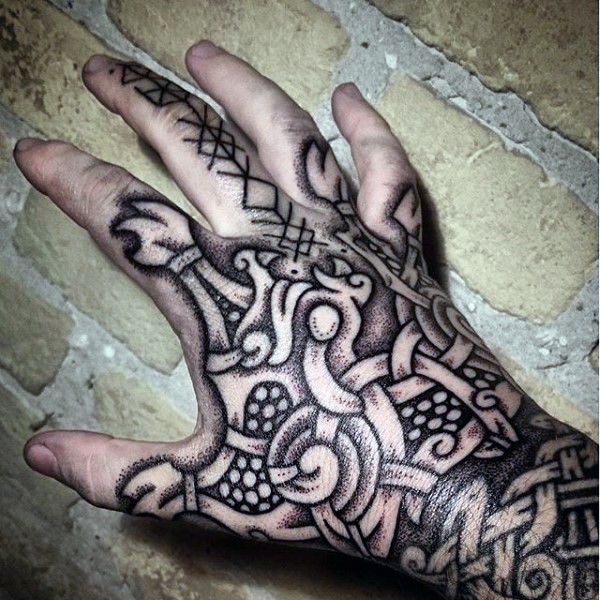Black ink detailed hand tattoo of Celtic ornament