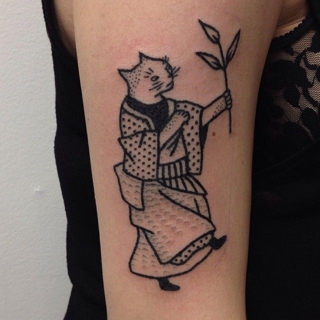 Black ink detailed shoulder tattoo of Asian cat with plant
