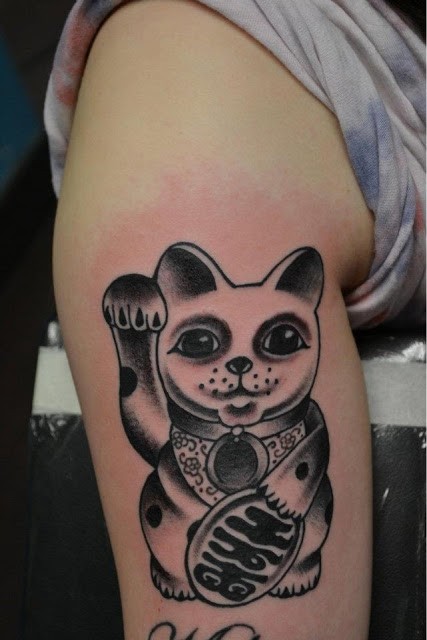 Black ink detailed tattoo of little maneki neko japanese lucky cat with ancient tablet