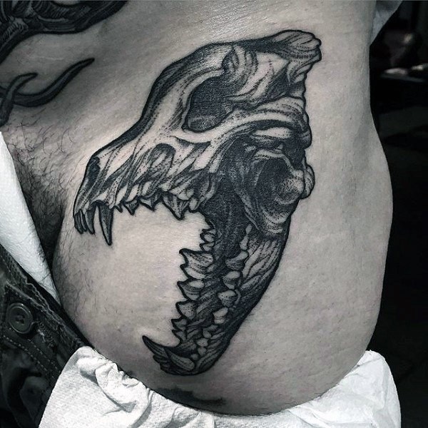 Black ink dot style animal skull tattoo on waist
