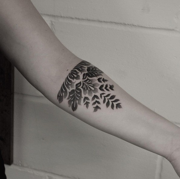 Black ink dot style forearm tattoo of nice looking plant